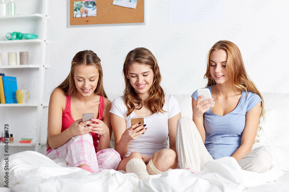 friends or teen girls with smartphone at home