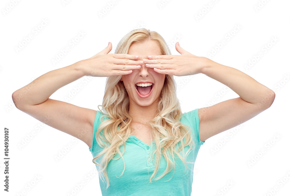 smiling young woman or teen girl covering her eyes