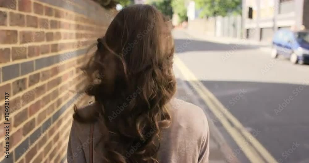 Beautiful woman walking through urban city streets Beautiful woman walking through urban city streets