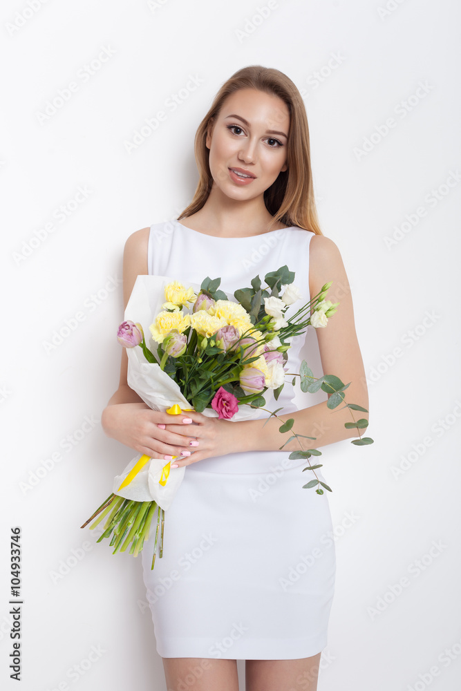 Young cute woman holding bunch of flowers Young cute woman holding bunch of flowers