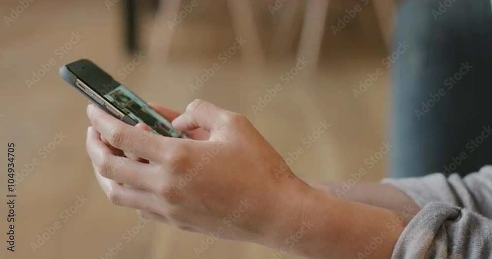Close up of Woman's flipping through vacation photos on smart phone at home Close up of Woman's flipping through vacation photos on smart phone at home