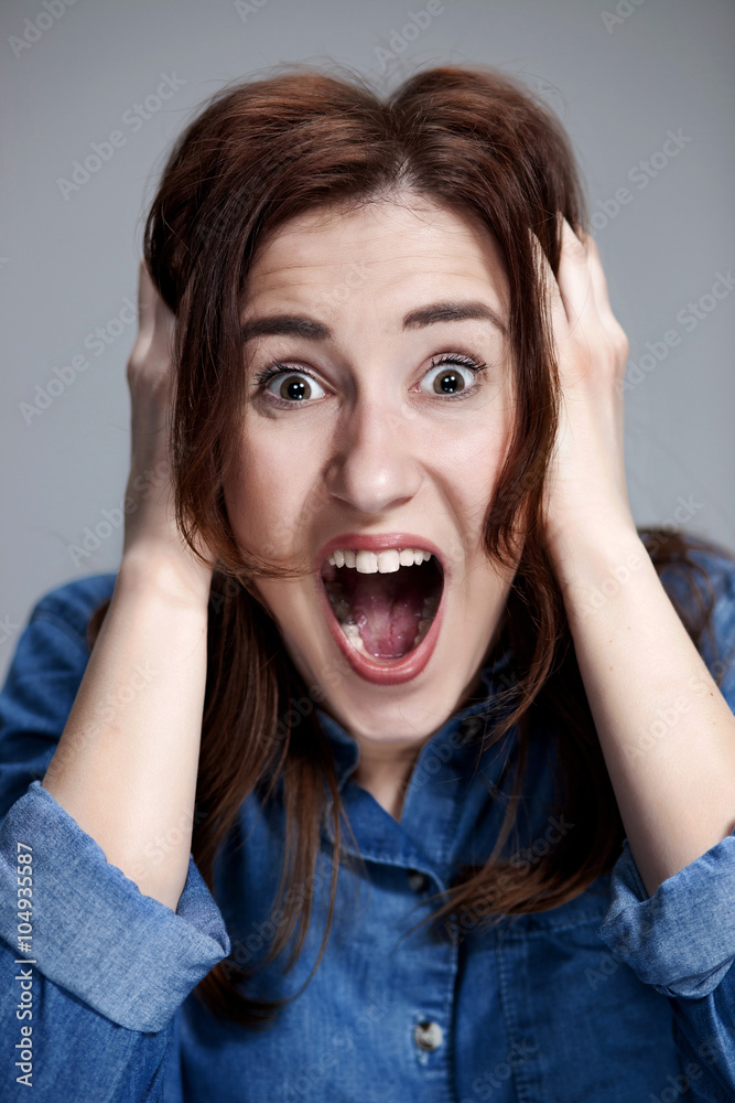 Portrait of young woman with shocked facial expression Portrait of young woman with shocked facial expression