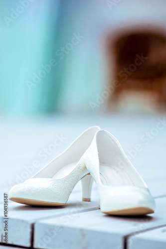 white wedding shoes on wooden background