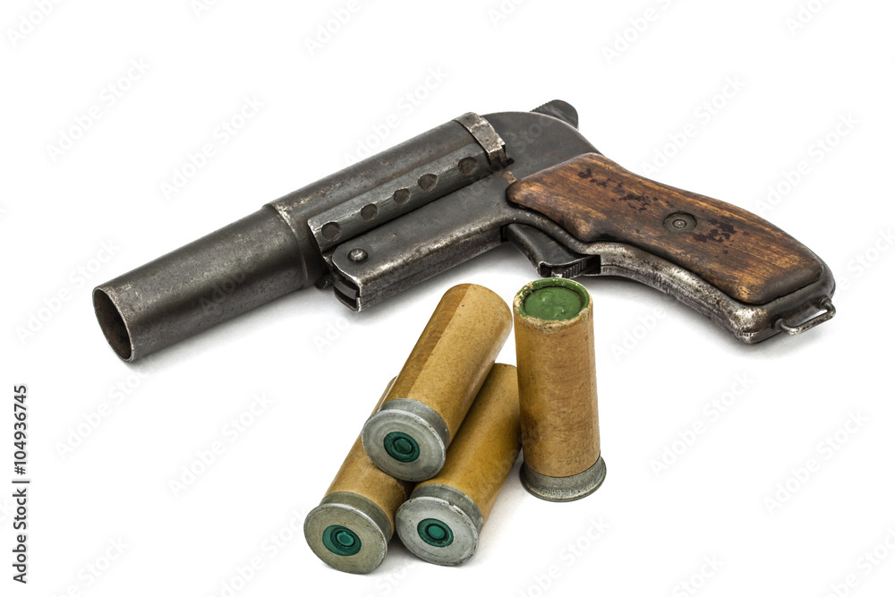 Old  signal pistol, flare gun and cartridges, isolated on white