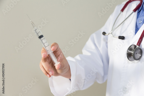 Female doctor  holding syringe with injection concept