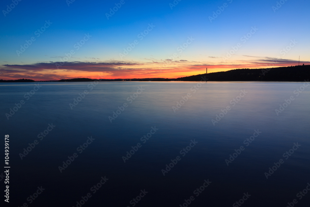 Fototapeta premium Calm sunset and clouds over lake