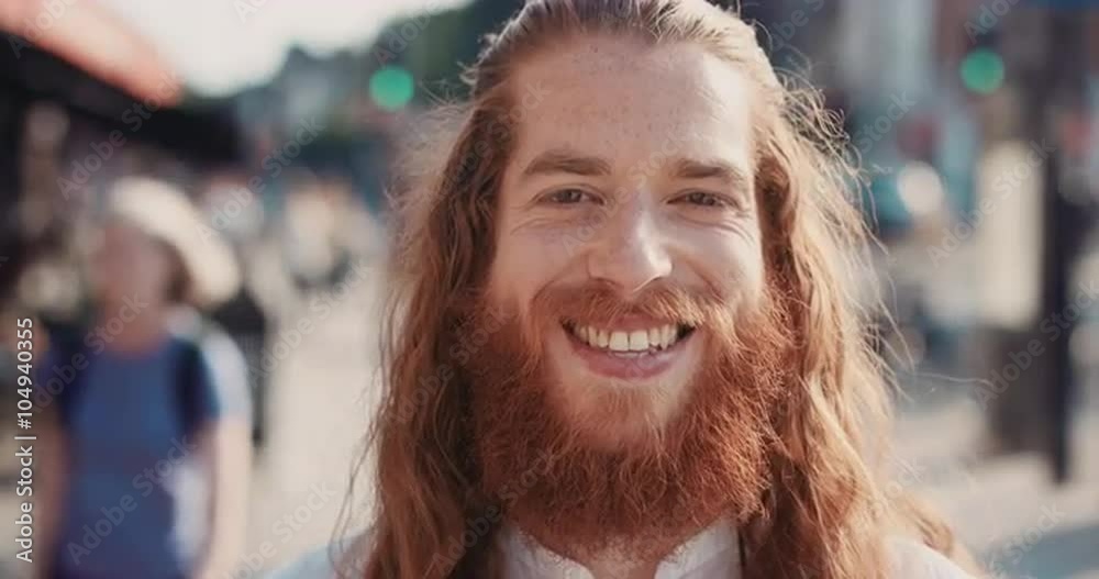 Slow Motion Portrait of happy hipster man with beard smiling