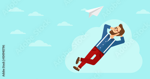 Businessman relaxing on cloud.