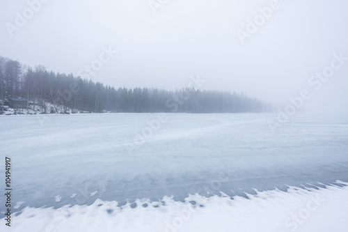 Thick fog at frozen lake landscape © Juhku