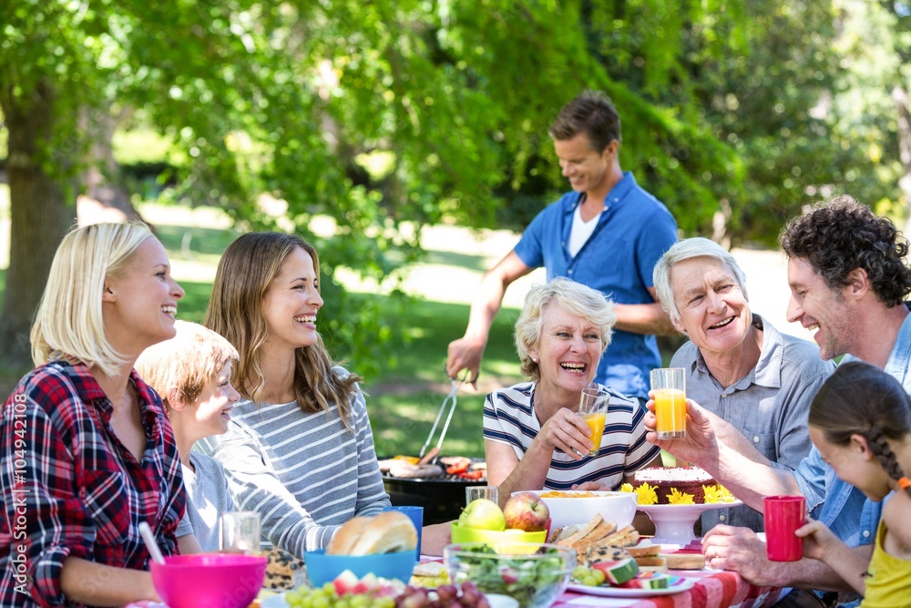 Family and friends having a picnic with barbecue