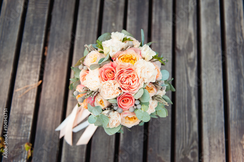 Bridal bouquet of roses on a  wooden planks © ruslan_shramko