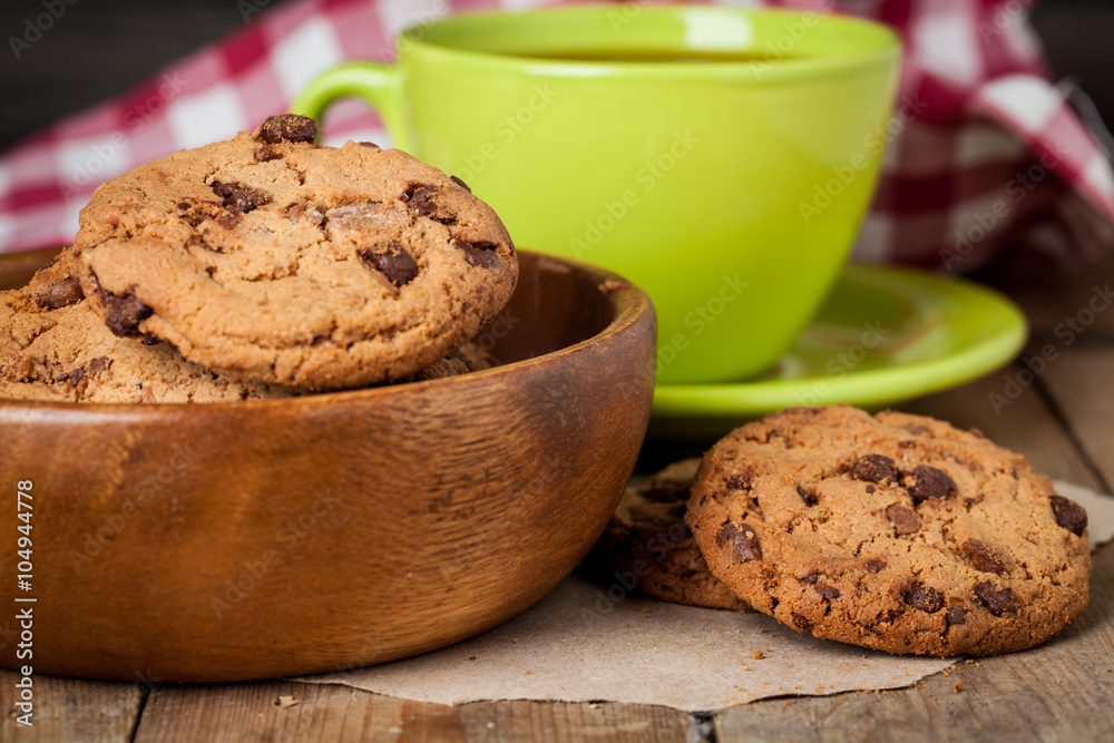 Fototapeta premium freshly baked chocolate chip cookies on rustic wooden table