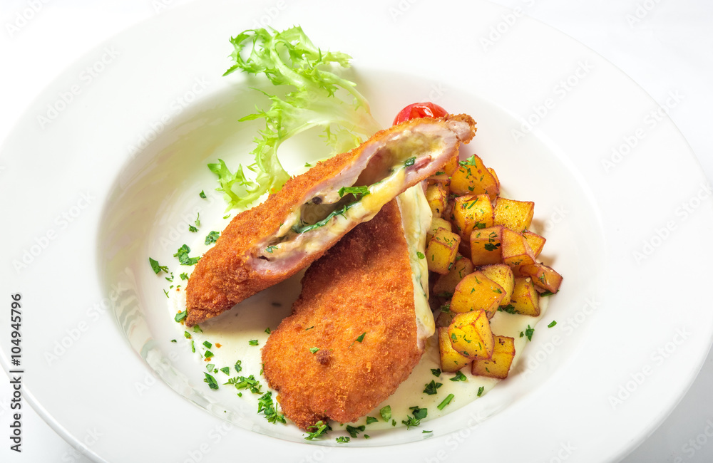 Cutting cordon bleu with cheese, turkey, crackers crumbs, potatoes. Cutting cordon bleu with cheese, turkey, crackers crumbs, potatoes.