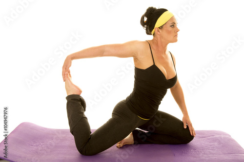 fitness woman in strap tank kneel pull foot up