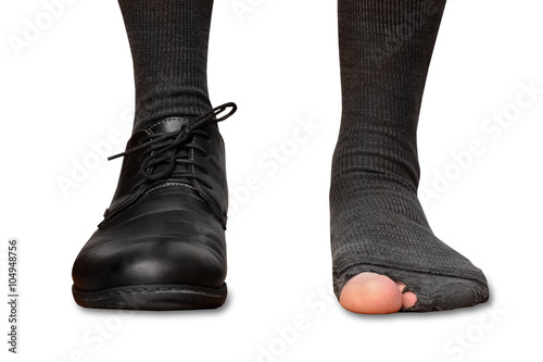 male feet in one Shoe and torn socks isolated on white background