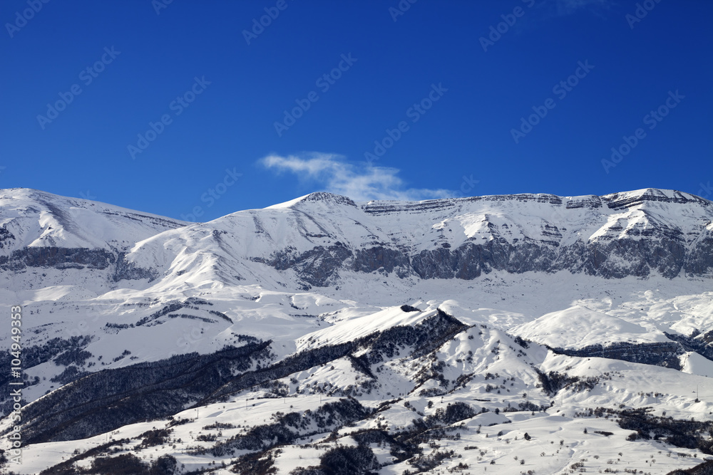 Snowy mountains and blue sky at nice sun day