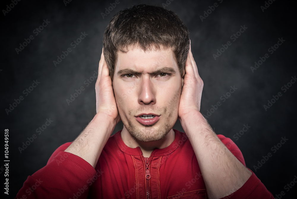Man covering his ears. Man covering his ears.