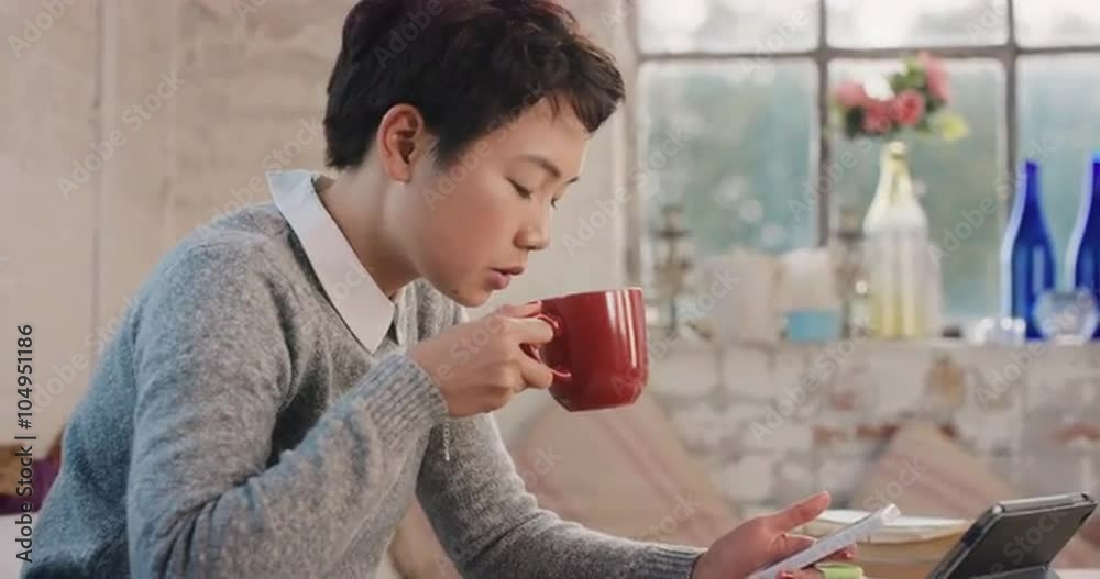 Young student using smart phone at home in morning drinking coffee Young student using smart phone at home in morning drinking coffee