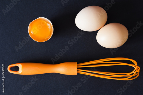 Broken eggs with a whisk. Free space for text