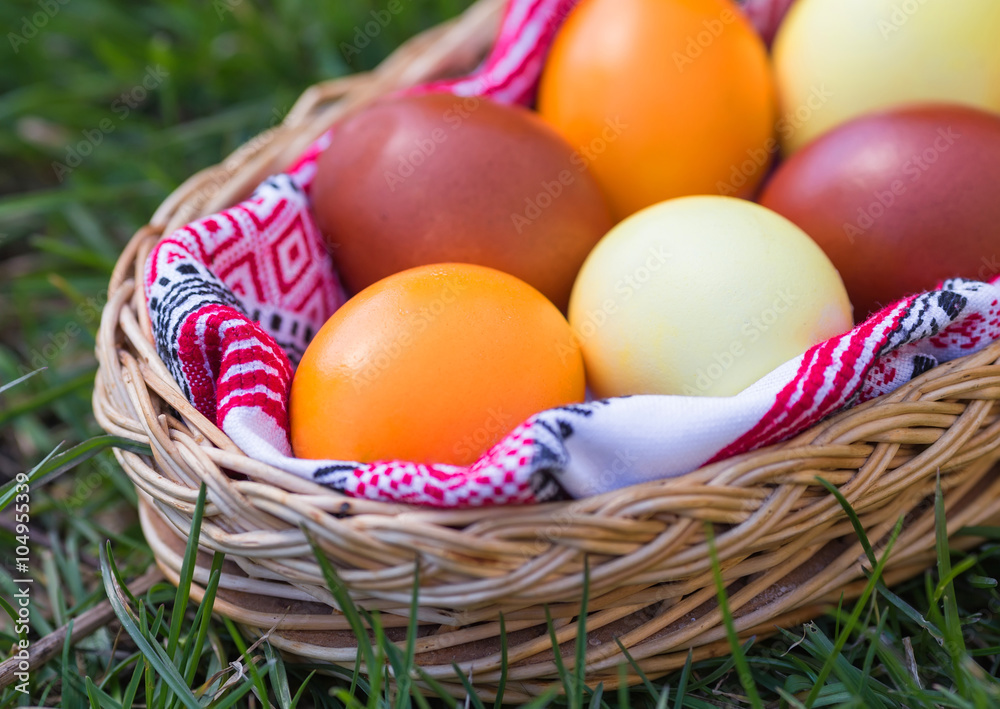 Unique hand painted Easter eggs in basket on grass. Traditional decoration in sun light Unique hand painted Easter eggs in basket on grass. Traditional decoration in sun light