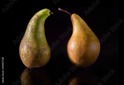 Two pears on a black background