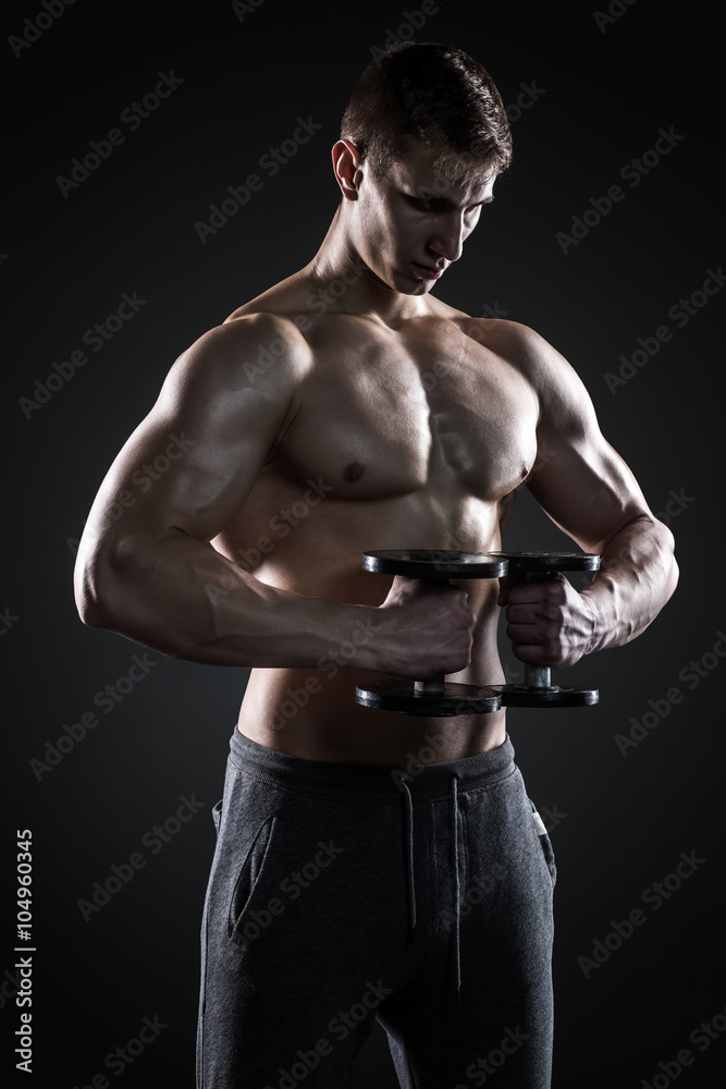 Mighty fitness man showing his gread body with dumbbells