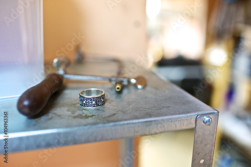 Close-up ring with silver-black design at jewelry workshop