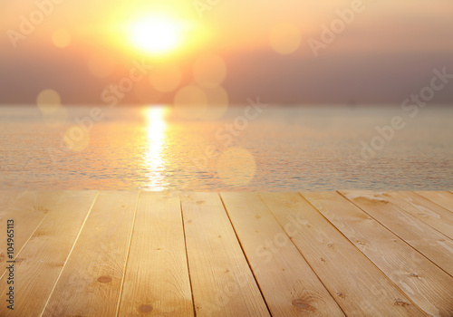 Wooden surface on blurred sea water background © Africa Studio