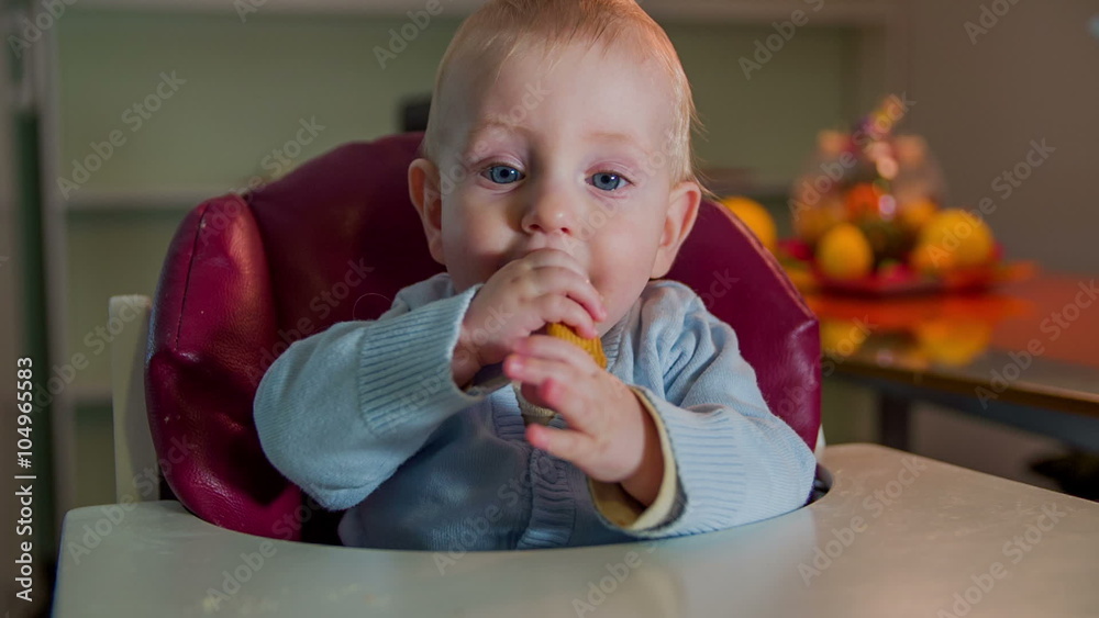 Just born child eating a biscuit wit his hands Just born child eating a biscuit wit his hands