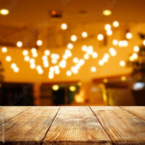 Empty wooden table and blurred interior background