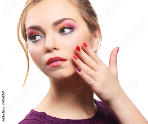 Beautiful girl with colorful makeup and manicure  isolated on white