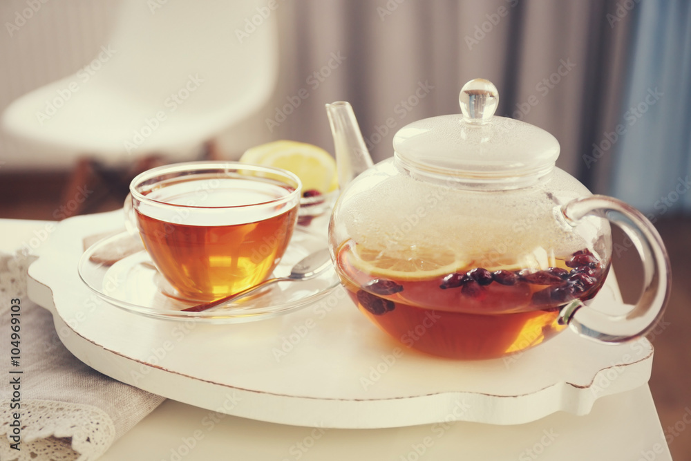 Tea set with hot tea and breakfast on a white wooden mat on the table Tea set with hot tea and breakfast on a white wooden mat on the table