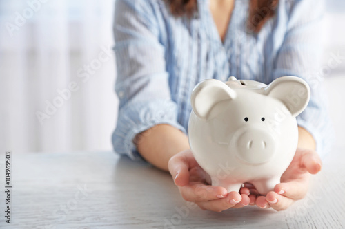 Woman holding piggy bank closeup