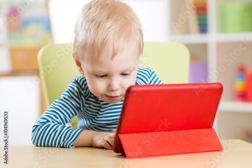 Child with tablet pc computer at home