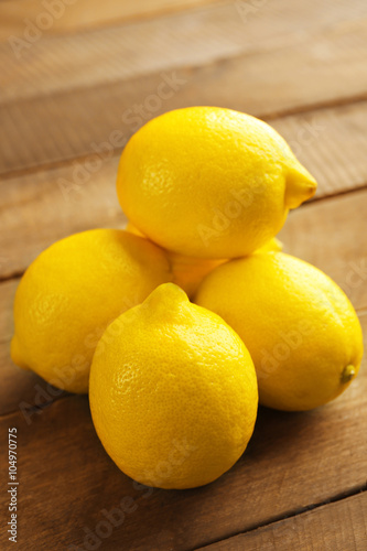 Fresh lemons on wooden background