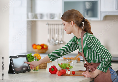 Young woman cooking in the ...