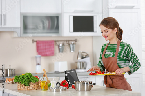 Young woman cooking in the ...