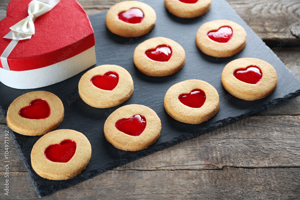 Assortment of love cookies with gift box on grey stand Assortment of love cookies with gift box on grey stand