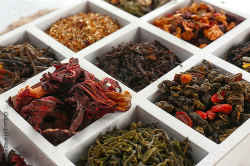 Variety of dry tea in wooden box, closeup