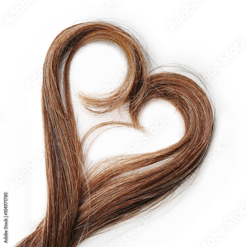 Photographie Strands of brown hair in shape of heart, isolated on white