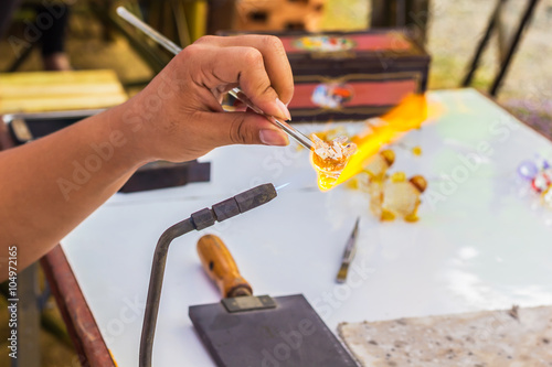 A photo of hand worker Glass blowing