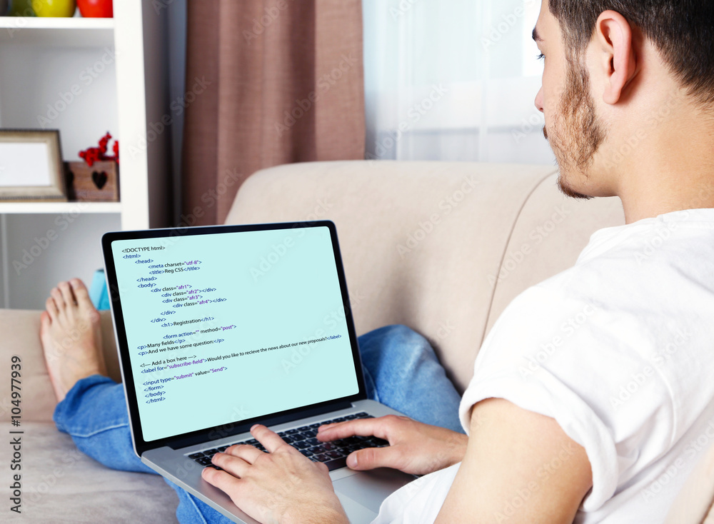 Man using laptop, writing programming code on laptop Man using laptop, writing programming code on laptop
