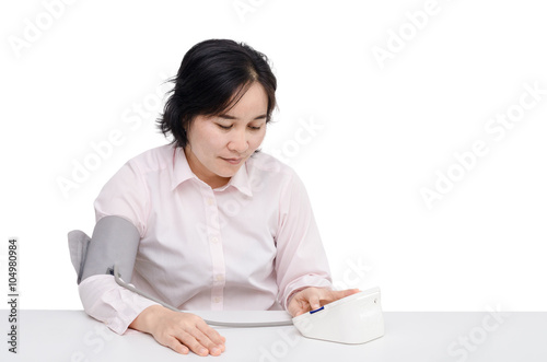 Asian woman checking blood pressure by herself