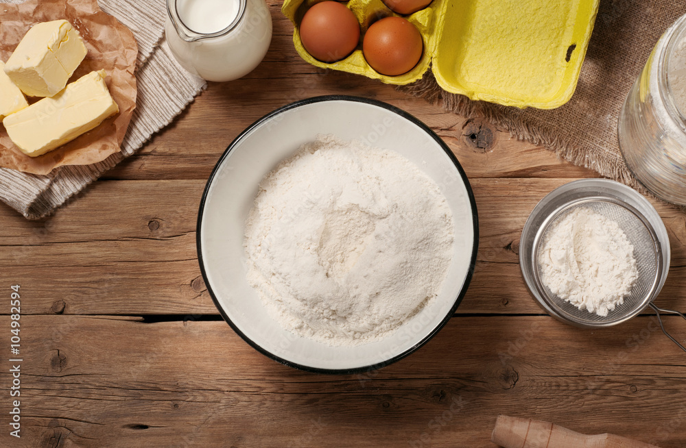 Flour in bowl with Ingredients for cooking bakery products