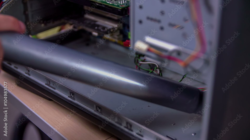 Using a vacuum cleaner in order to clean the dust on inner parts of the computer