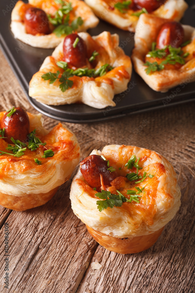 Freshly baked muffins with sausage, cheese and onion closeup. Vertical
Freshly baked muffins with sausage, cheese and onion closeup. Vertical