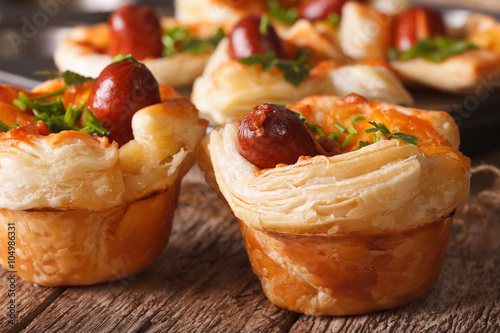 Beautiful snack muffins with sausage, cheese and onion macro. horizontal
