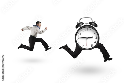 Man running after alarm clock of running legs