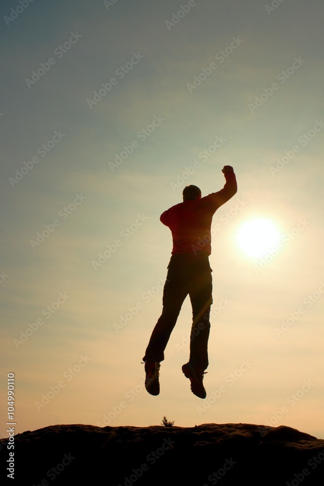 Jumping man. Young crazy man is jumping on colorful sky background.Silhouette of jumping man and beautiful sunset sky. Jumping man. Young crazy man is jumping on colorful sky background.Silhouette of jumping man and beautiful sunset sky.