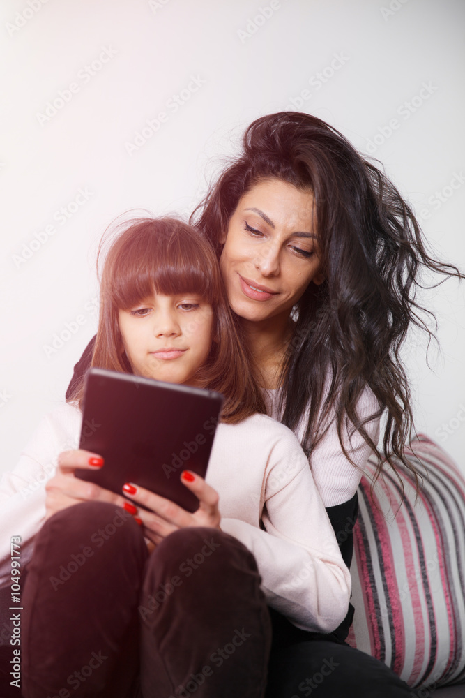 Mother and daughter looking at digital tablet Mother and daughter looking at digital tablet